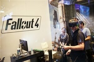 An attendee uses an HTC Vive VR headset to play the "Fallout 4" video games by Bethesda Softworks LLC during the E3 Electronic Entertainment Expo in Los Angeles, California, U.S., on Wednesday, June 15, 2016. E3, a trade show for computer and video games, draws professionals to experience the future of interactive entertainment as well as to see new technologies and never-before-seen products. Photographer: Patrick T. Fallon/Bloomberg