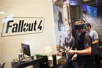 An attendee uses an HTC Vive VR headset to play the "Fallout 4" video games by Bethesda Softworks LLC during the E3 Electronic Entertainment Expo in Los Angeles, California, U.S., on Wednesday, June 15, 2016. E3, a trade show for computer and video games, draws professionals to experience the future of interactive entertainment as well as to see new technologies and never-before-seen products. Photographer: Patrick T. Fallon/Bloomberg